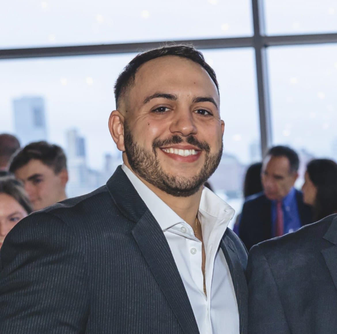 Scad, publicly known as ScadMeta (@ScadMeta), in a grey suit and open white shirt